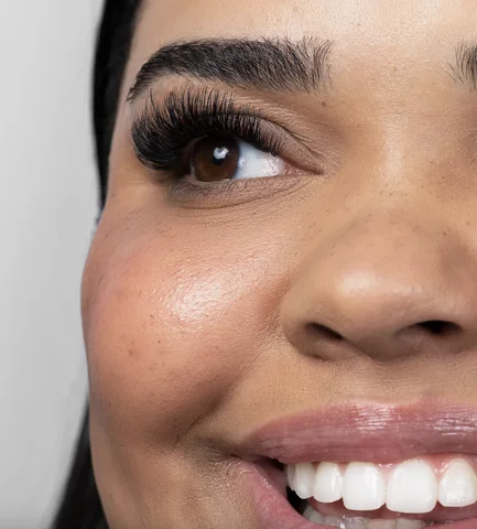 Close-up of a smiling woman with full volume lashes